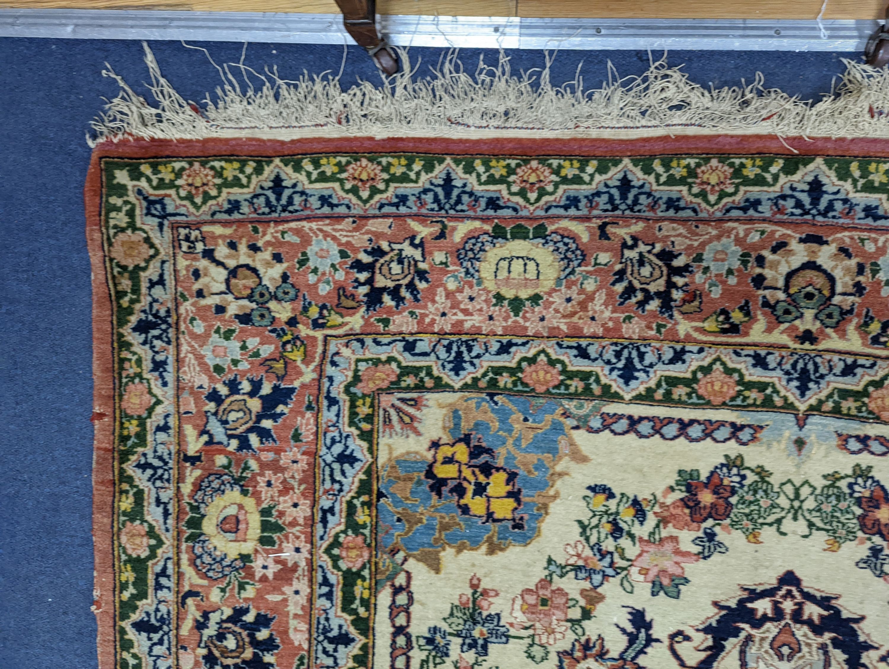 A part silk Isfahan cream rug with central floral scroll medallion, 196 x 140cm